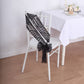 Black geometric diamond glitz sequin chair sash on a white chair.