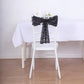 Black geometric diamond sequin chair sash on a white chair.