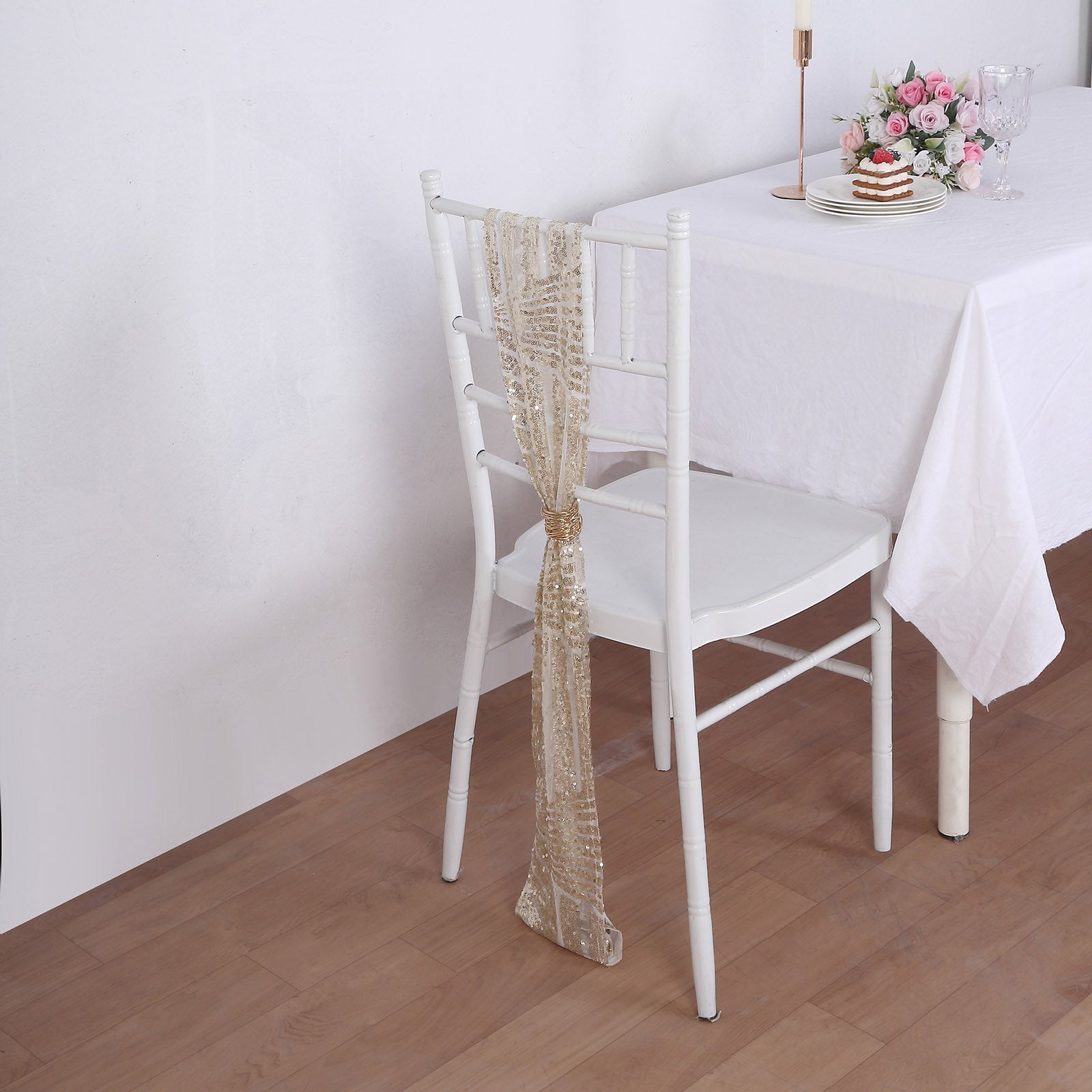 Champagne geometric diamond glitz sequin chair sashes on a white chair.