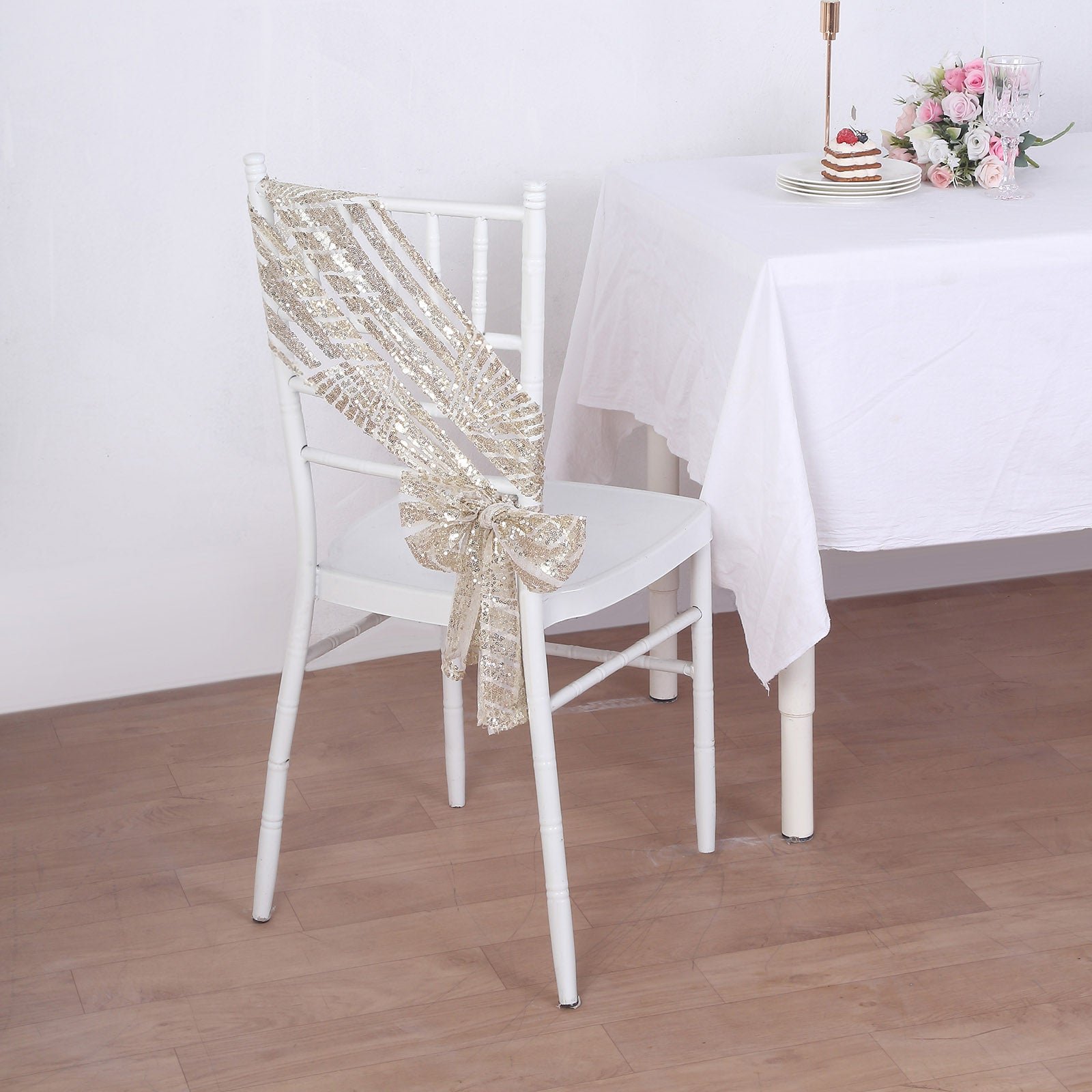 Champagne geometric diamond glitz sequin chair sash on a white chair.