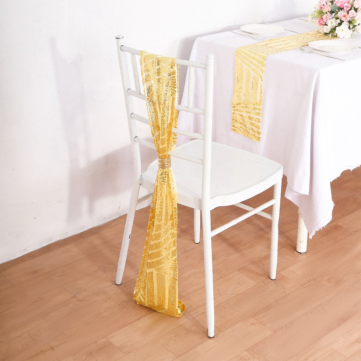 Gold sequin chair sash draped elegantly on a white chair.