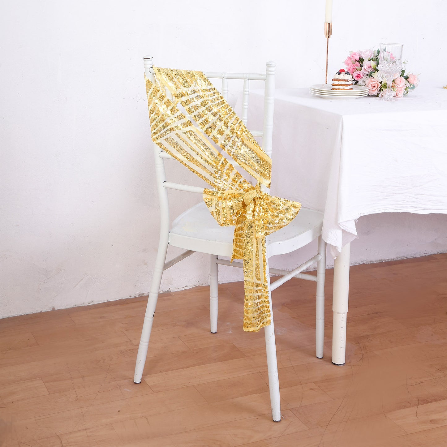 Gold geometric diamond glitz sequin chair sash on a white chair.