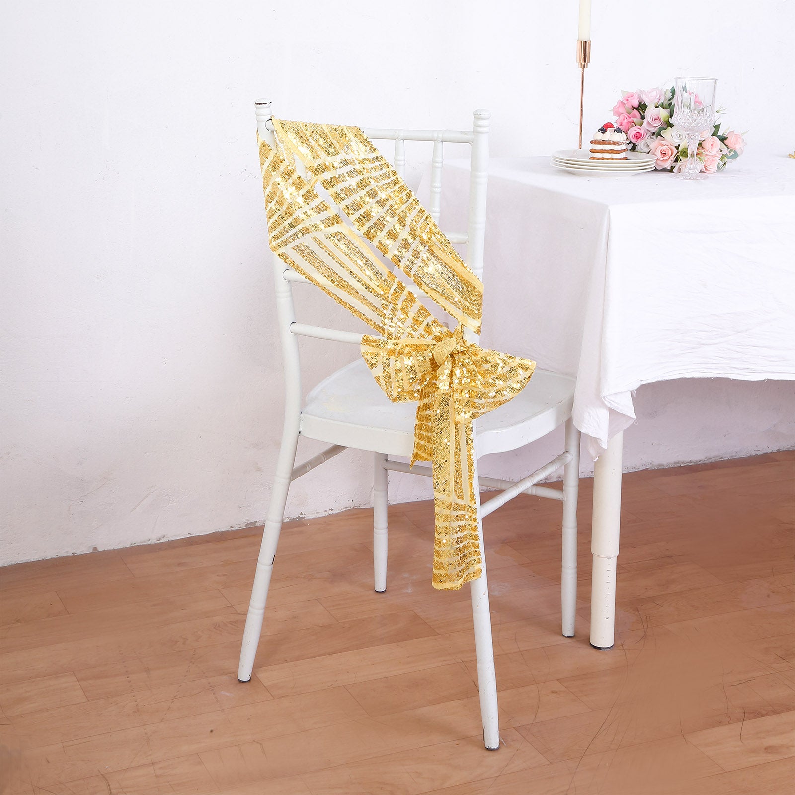 Gold geometric diamond glitz sequin chair sash on a white chair.