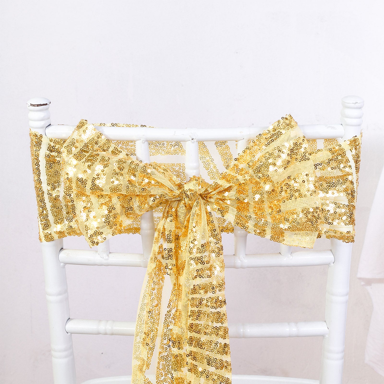 Gold geometric sequin chair sash for elegant decor.
