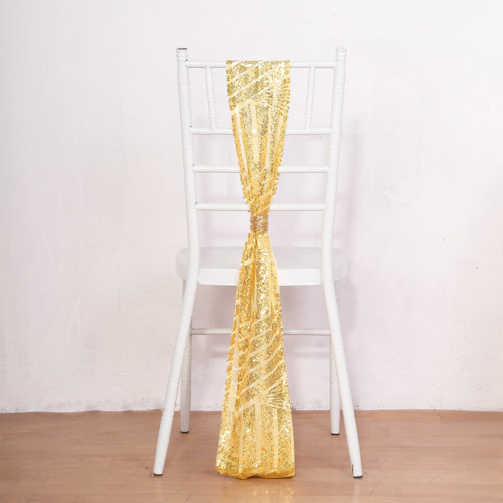 Gold Geometric Diamond Sequin Chair Sash on a white chair.