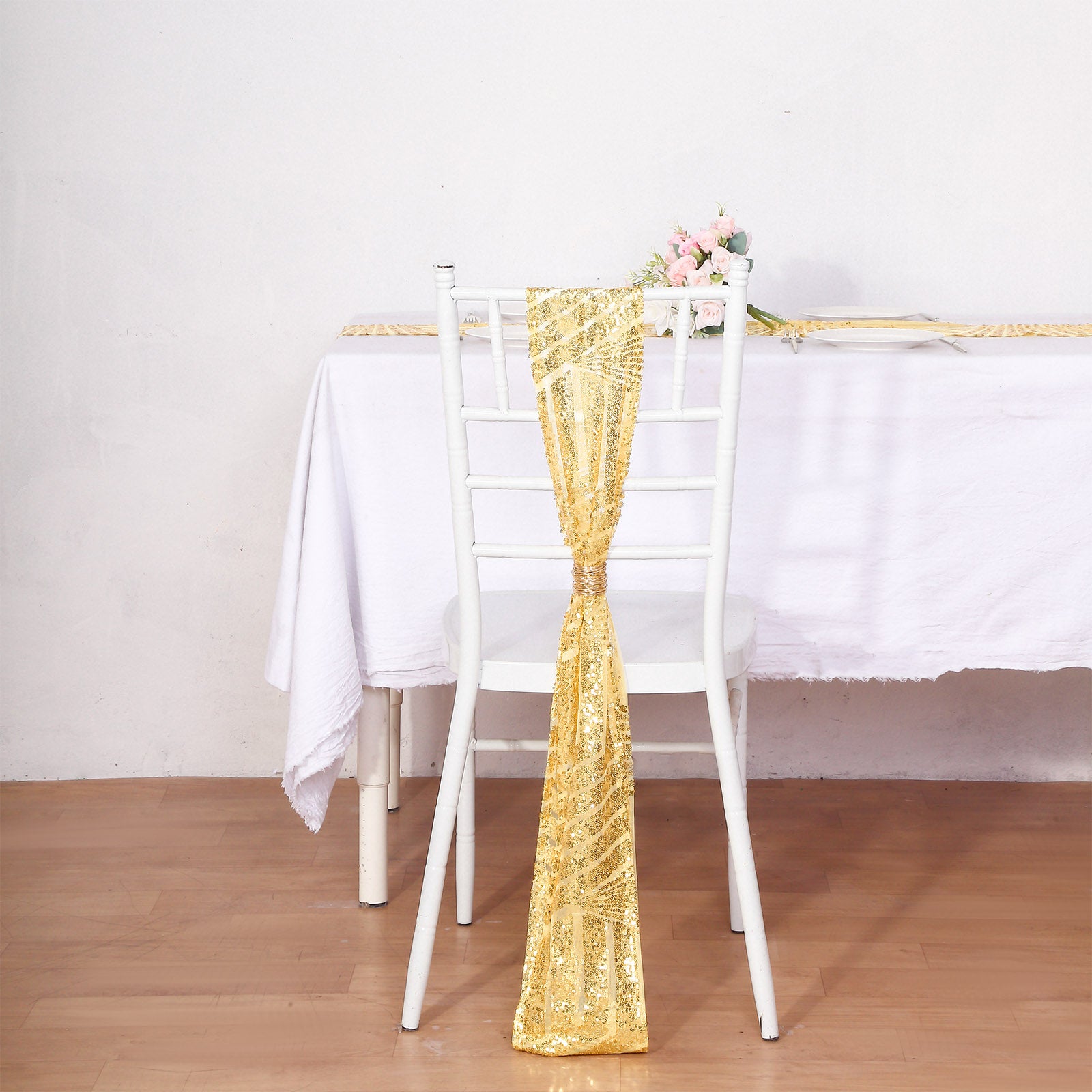 Gold geometric diamond glitz sequin chair sash on a white chair.