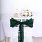 Emerald green sequin chair sash tied on a white chair.