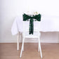 Emerald green sequin chair sash on a white chair at a dining table.