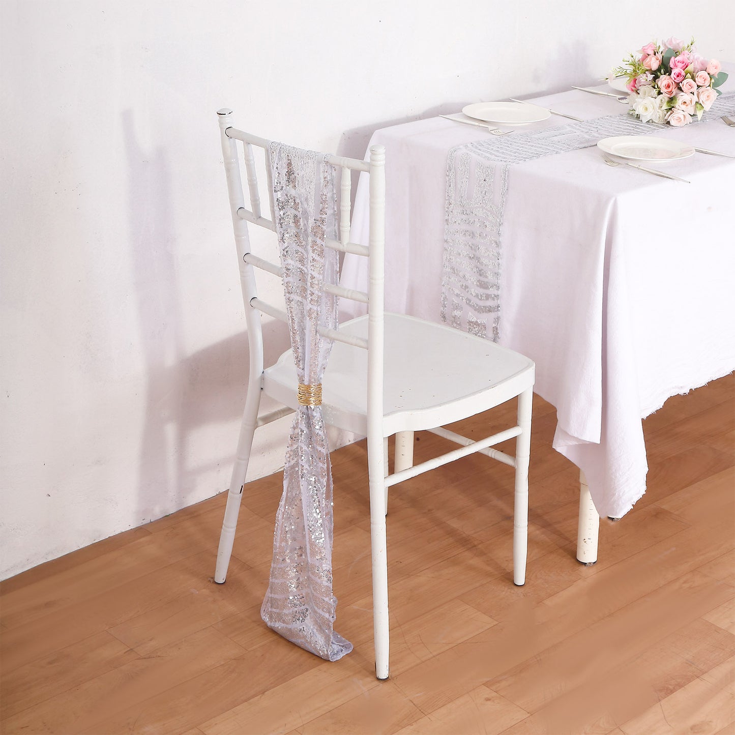 Silver geometric diamond glitz sequin chair sash on a white chair.