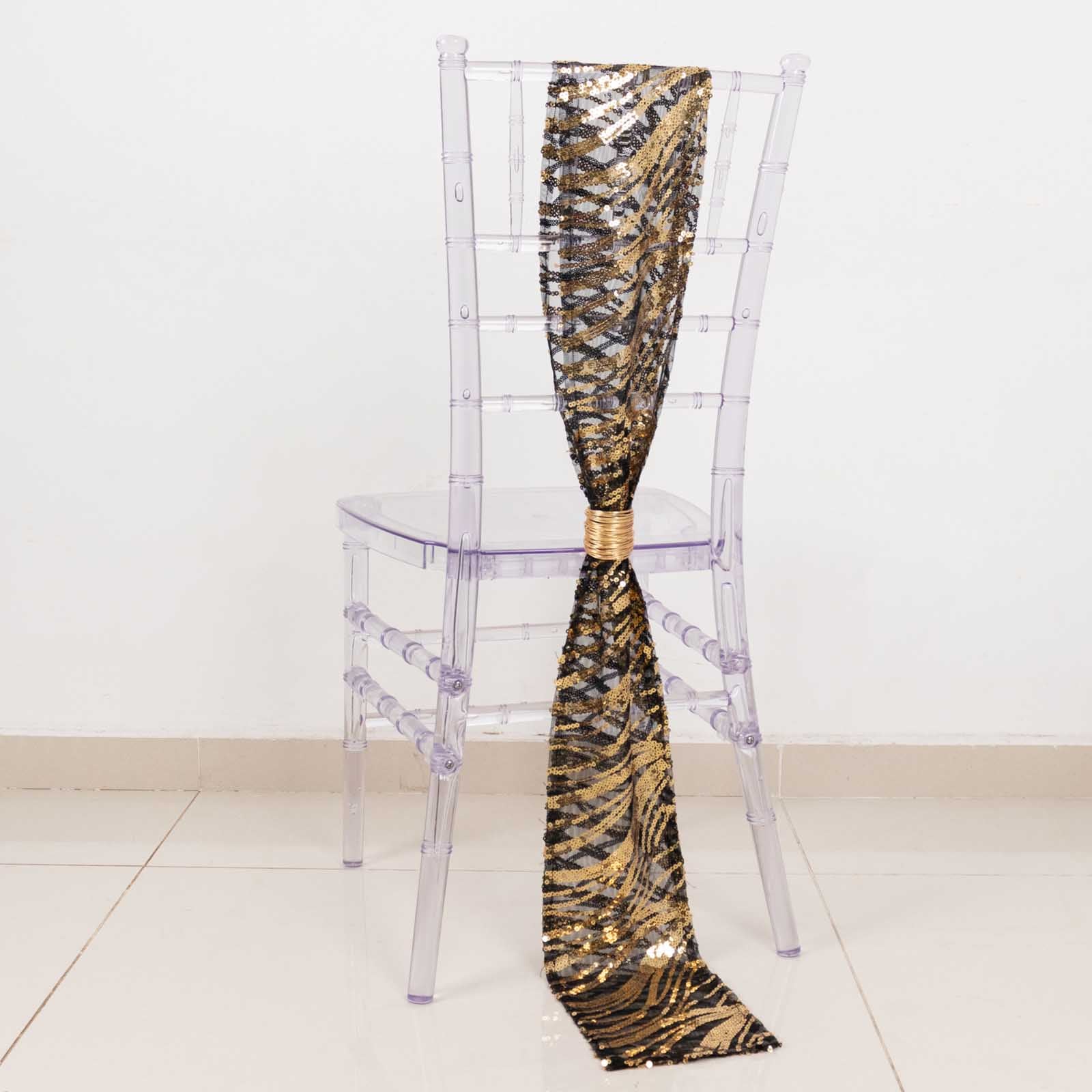 Black gold wave embroidered sequin mesh chair sash on transparent chair.
