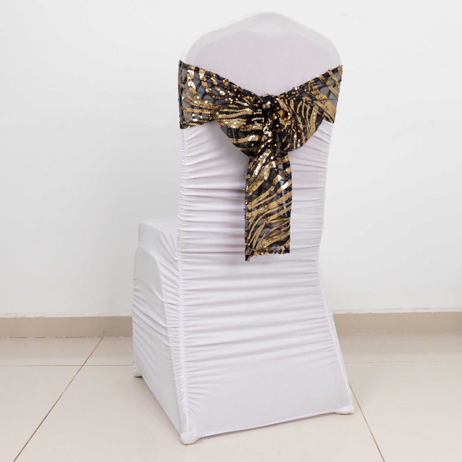 Black gold wave embroidered sequin mesh chair sash on a white chair.