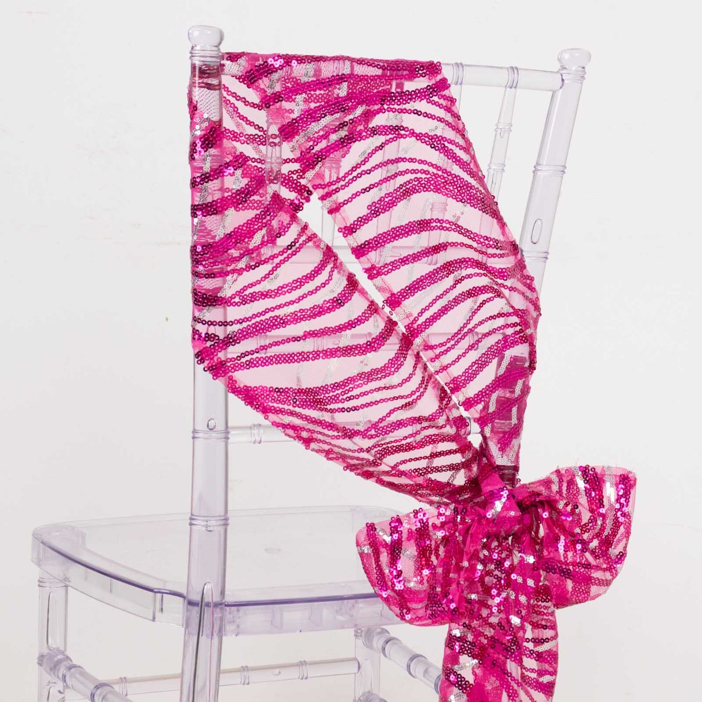 Fuchsia sequin mesh chair sash with silver wave pattern.