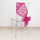 Fuchsia sequin mesh chair sash tied on a transparent chair.