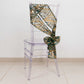 Hunter emerald green and gold wave sequin chair sash on a clear chair.