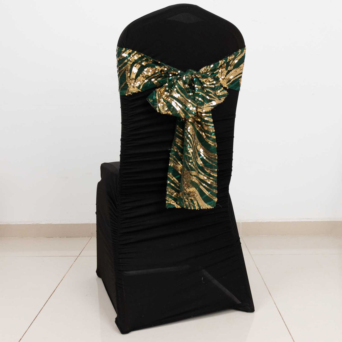 Hunter emerald green gold wave sequin chair sash on a black chair.