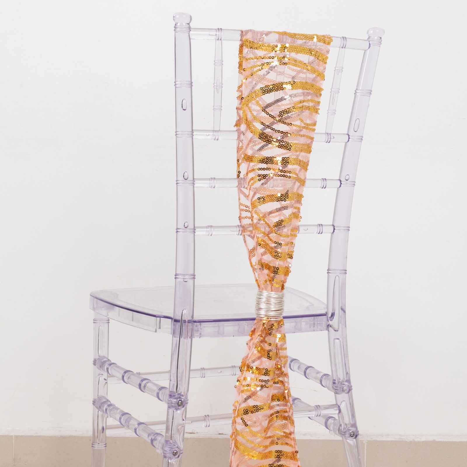 Rose gold mesh chair sash with gold wave sequins on a clear chair.