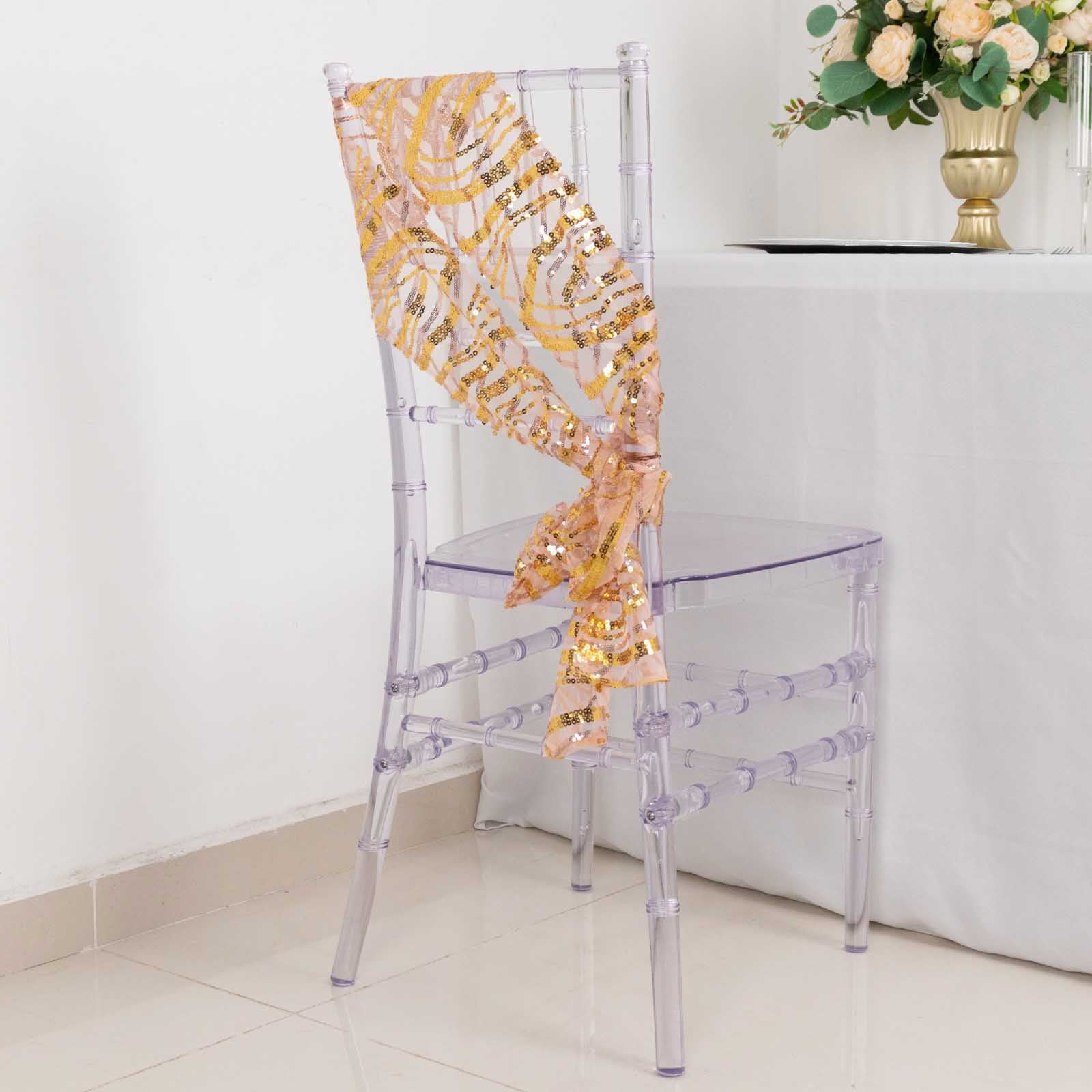Rose gold mesh chair sash with gold wave sequins draped on a clear chair.