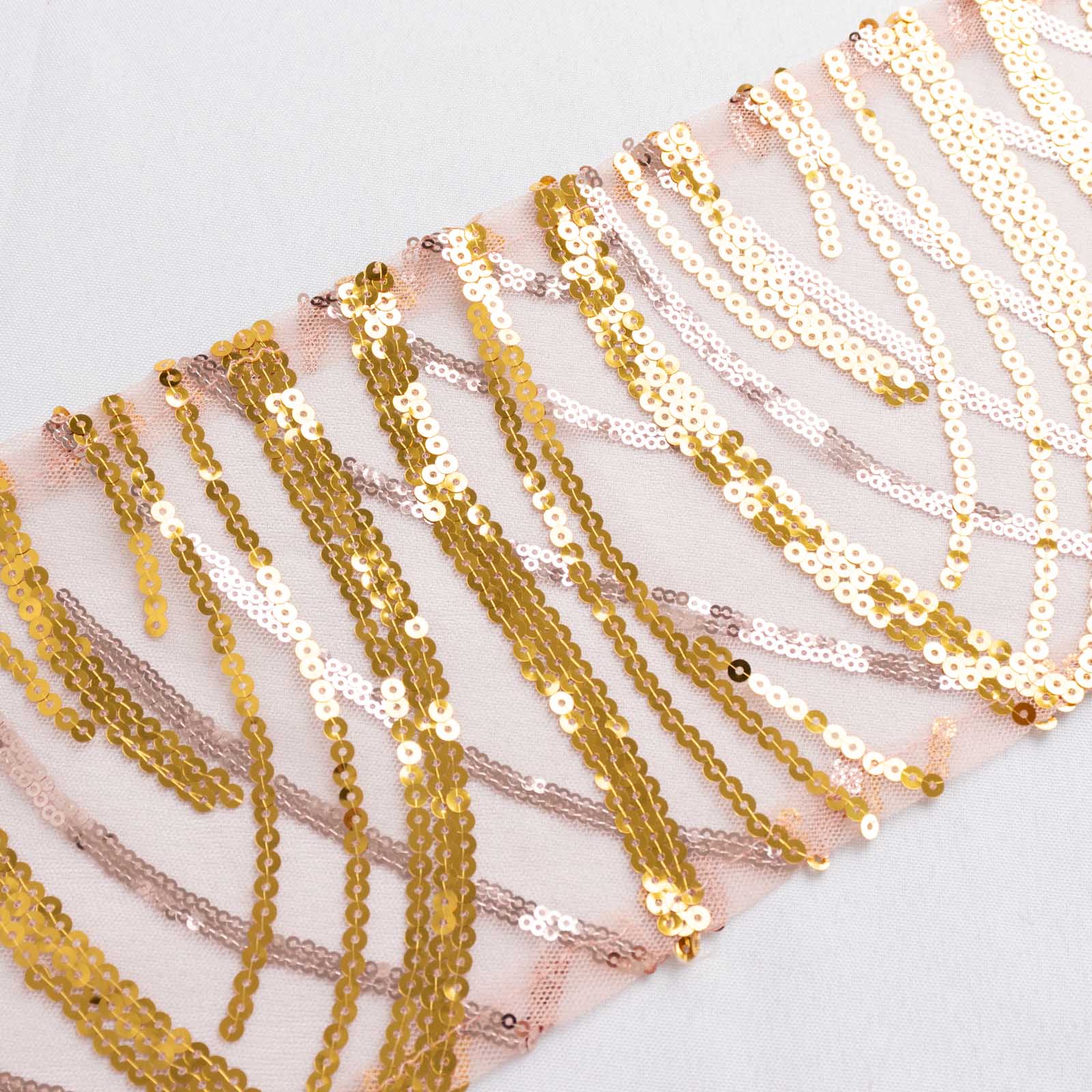 Rose gold mesh chair sash with gold wave embroidered sequins.