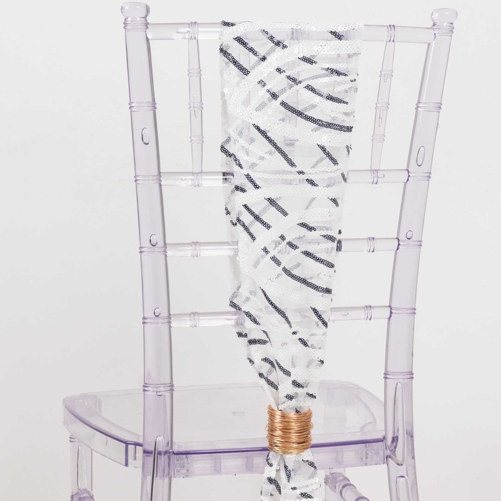 White and black wave embroidered sequin mesh chair sash on a transparent chair.