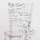 White and black wave embroidered sequin mesh chair sash on a clear chair.