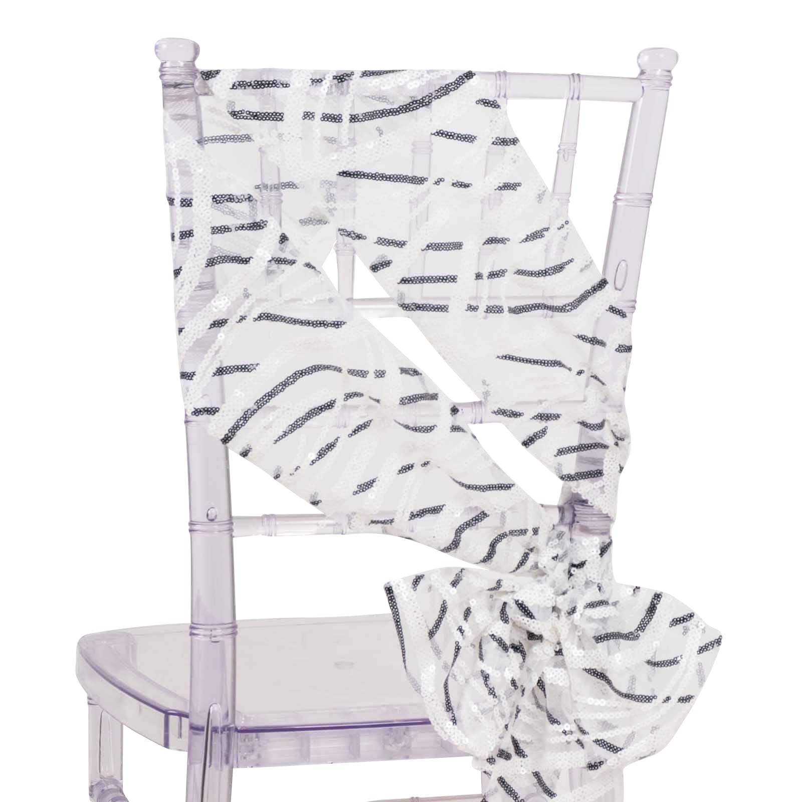 White and black wave embroidered sequin chair sash on a clear chair.