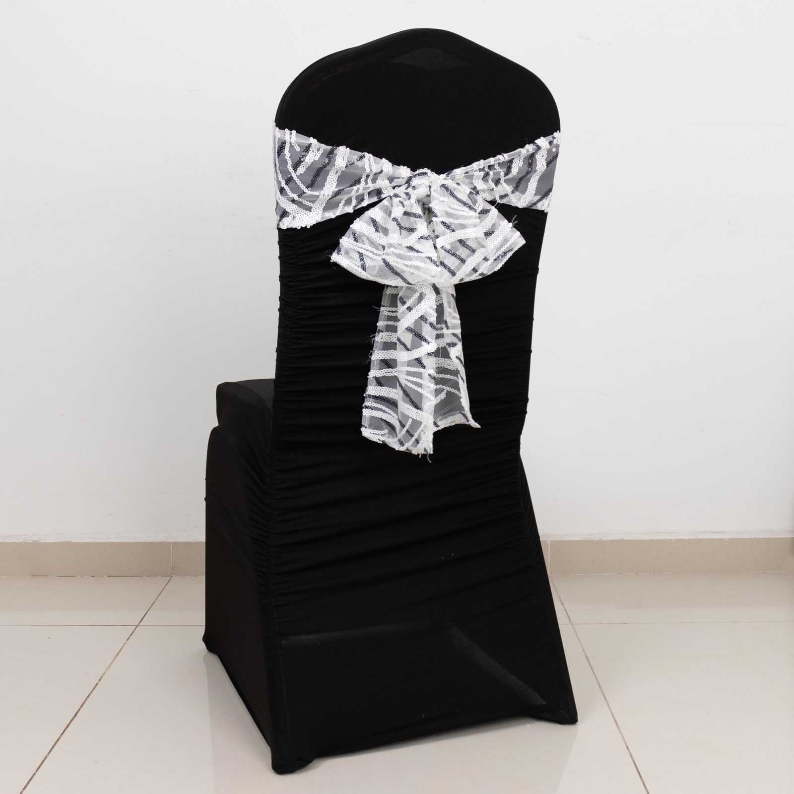 White and black wave embroidered sequin chair sash on a black chair.