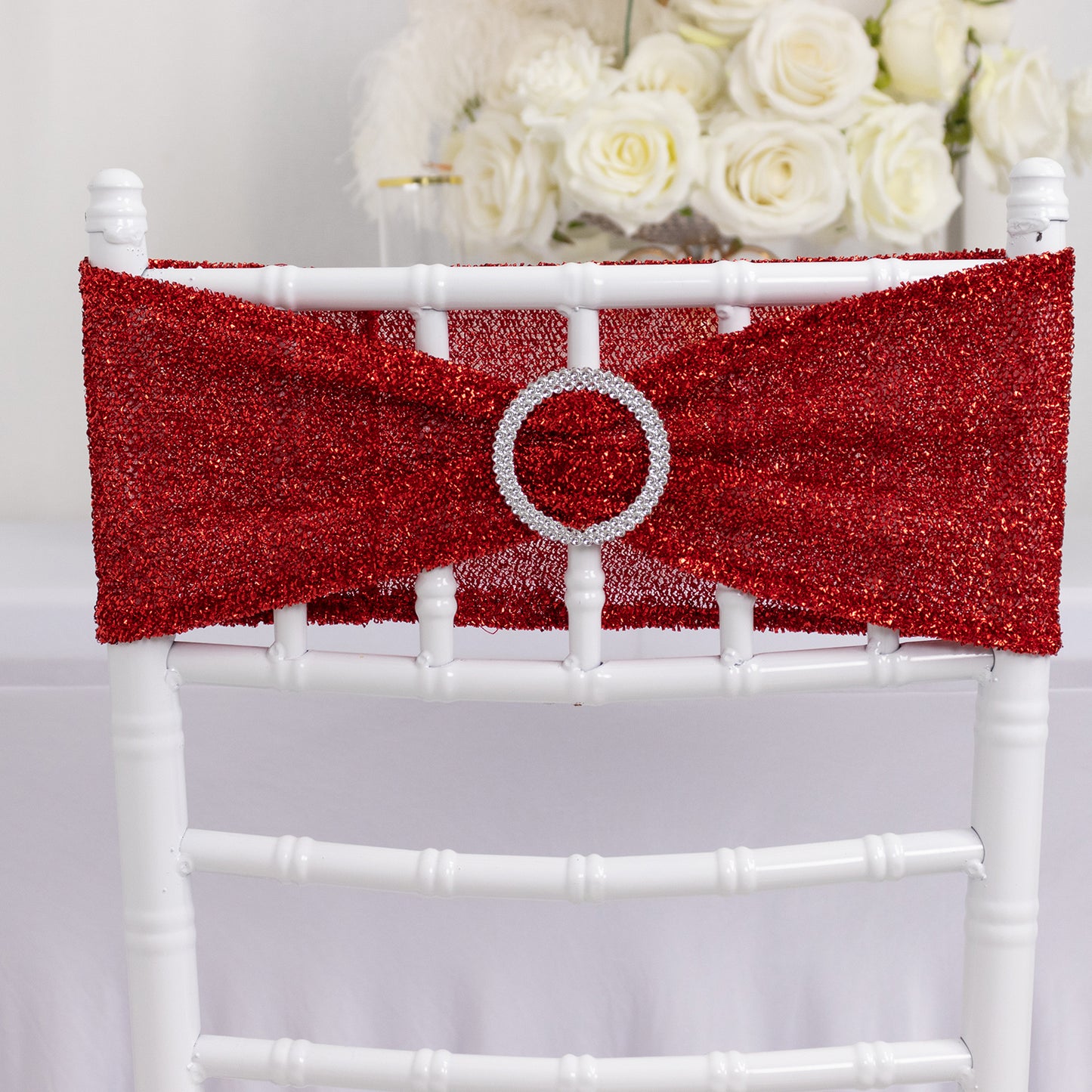 Red shimmer tinsel stretch chair sash with silver rhinestone buckle.
