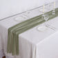 6ft Dusty Sage Green Chiffon Table Runner on a white tablecloth with dinnerware.