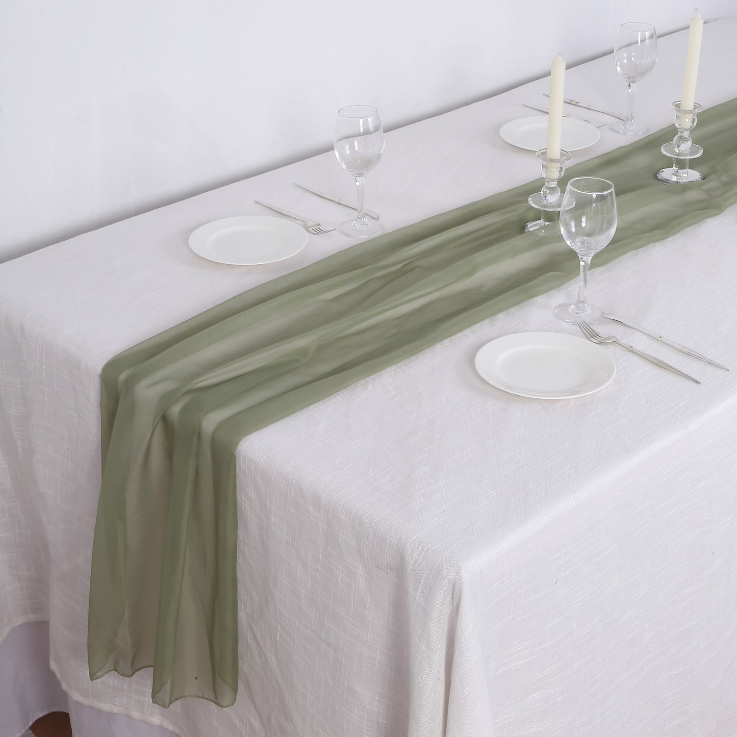6ft Dusty Sage Green Chiffon Table Runner on a white tablecloth with dinnerware.