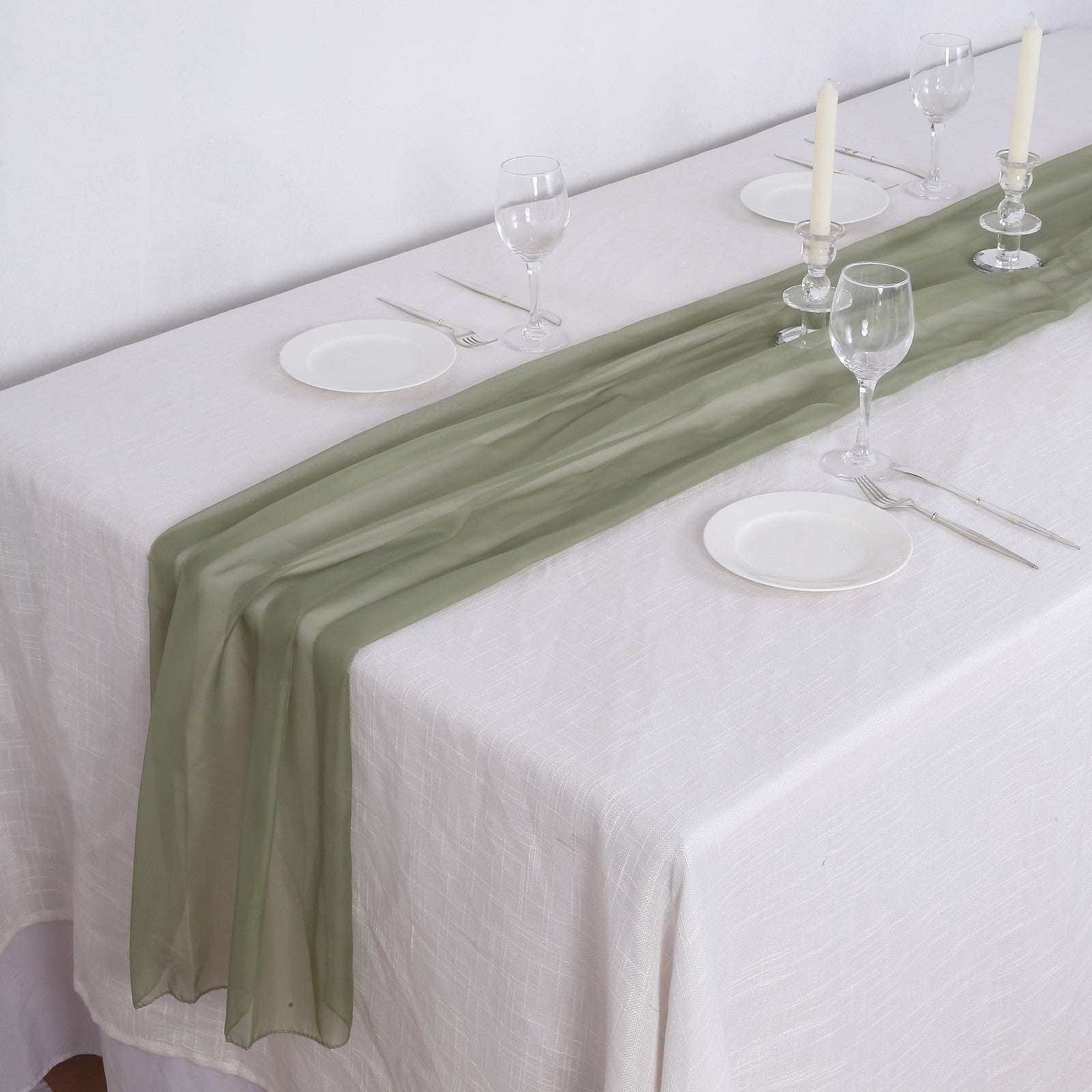6ft Dusty Sage Green Chiffon Table Runner on a white tablecloth with dinnerware.