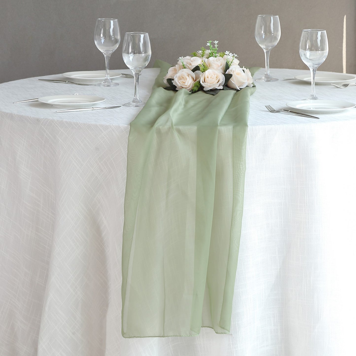 6ft Dusty Sage Green Chiffon Table Runner on a dining table with floral decor.