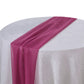 Fuchsia chiffon table runner on a white tablecloth.