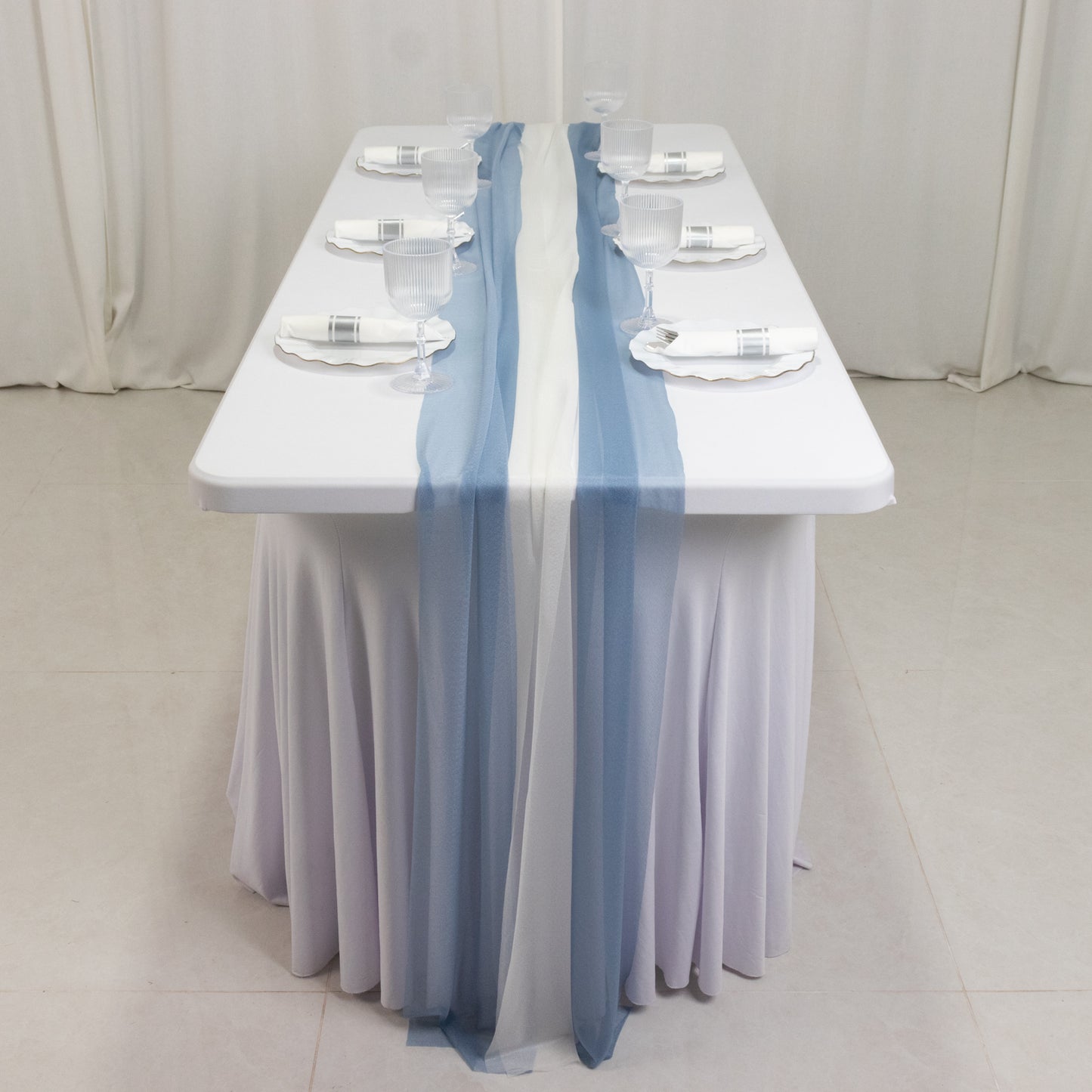 Dusty blue and ivory sheer table runners on a white table.