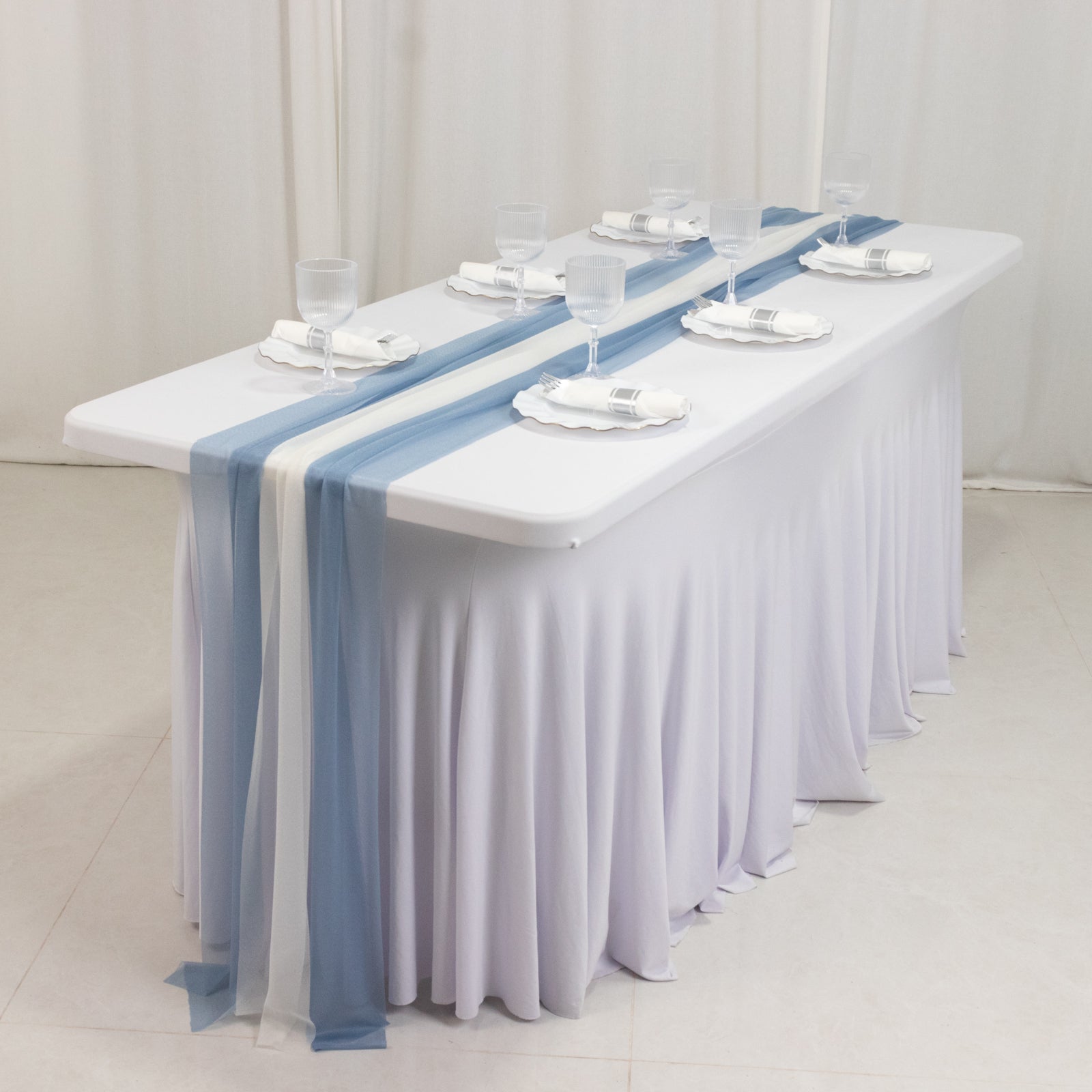 Dusty blue and ivory sheer table runners on a white table.