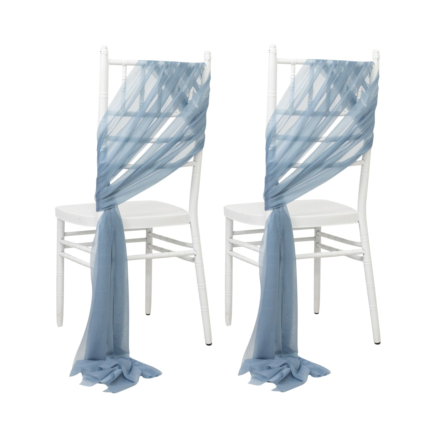 Dusty blue sheer chair drapes elegantly styled on white chairs.