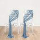 Dusty blue sheer chair drapes elegantly arranged on white chairs.