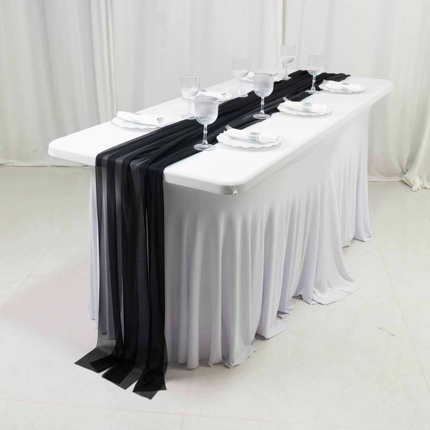 Black shimmer sheer table runners on a white table setting.