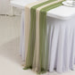Dusty sage green and beige sheer table runners on a white table.