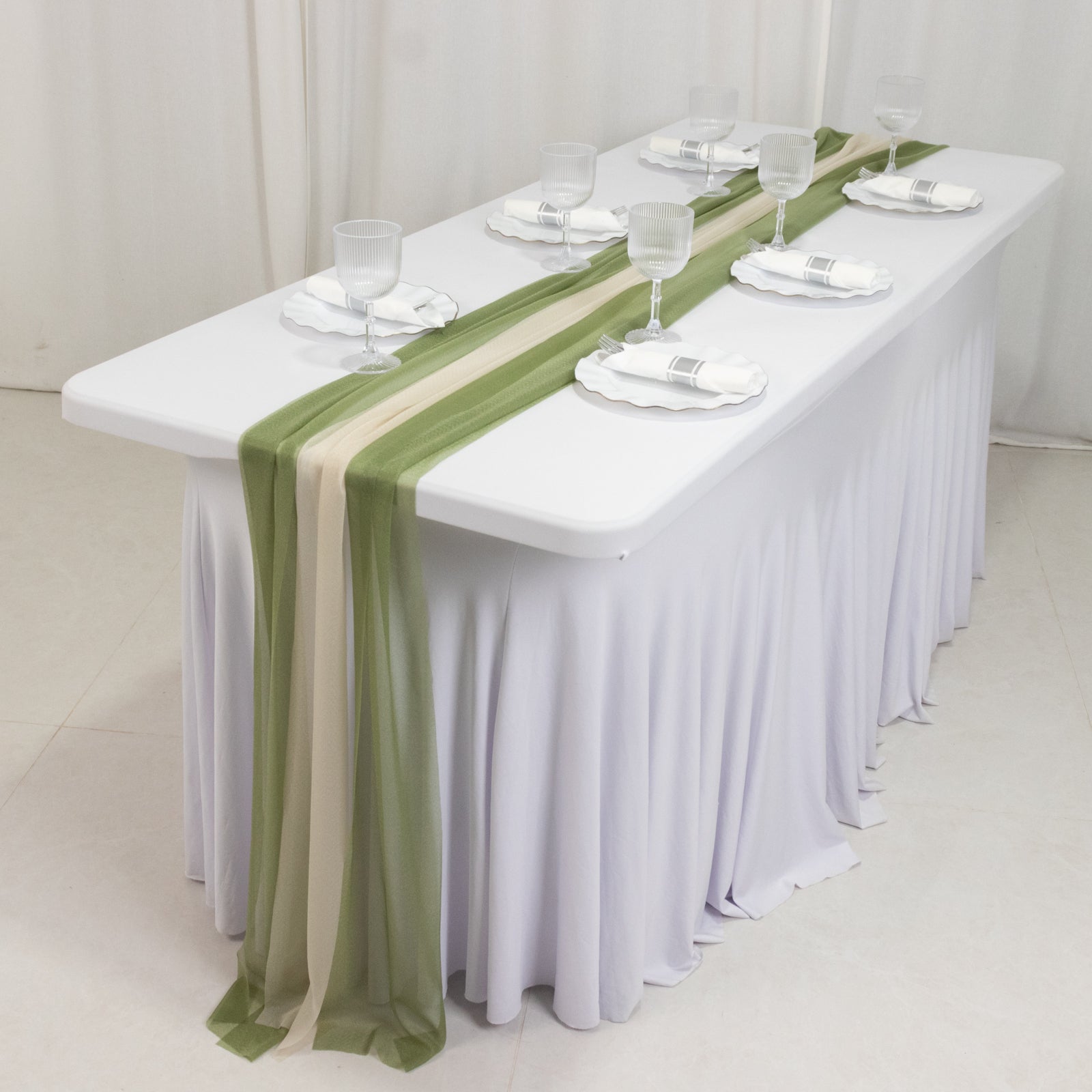 Dusty sage green and beige sheer table runners on a white table.