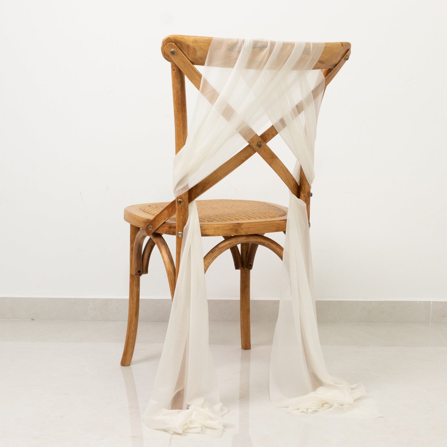 Ivory sheer chair drape with 9ft shimmer sash, wrinkle-free decor.