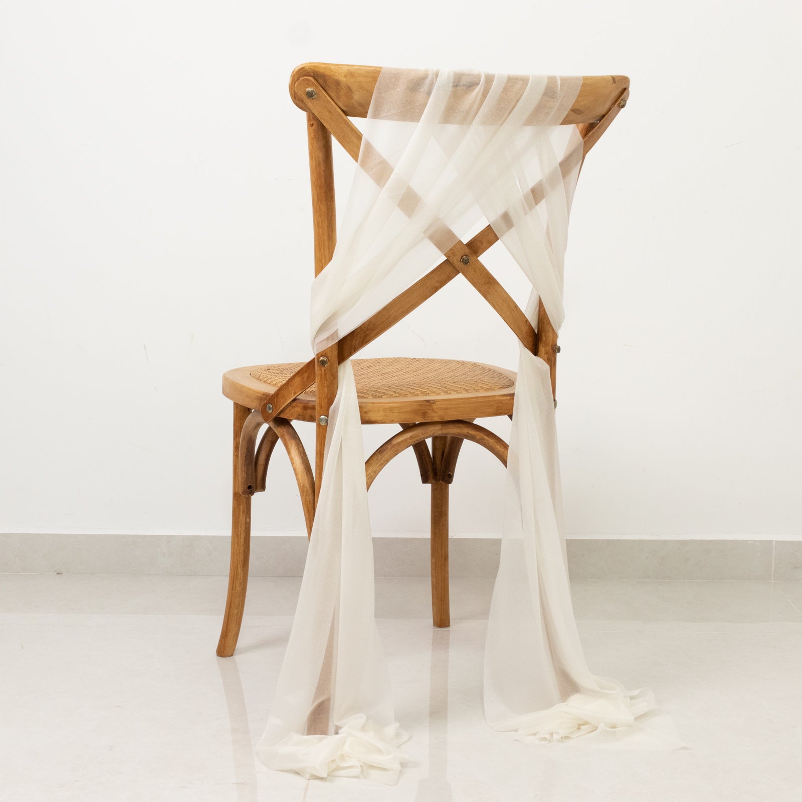 Ivory sheer chair drape with 9ft shimmer sash, wrinkle-free decor.