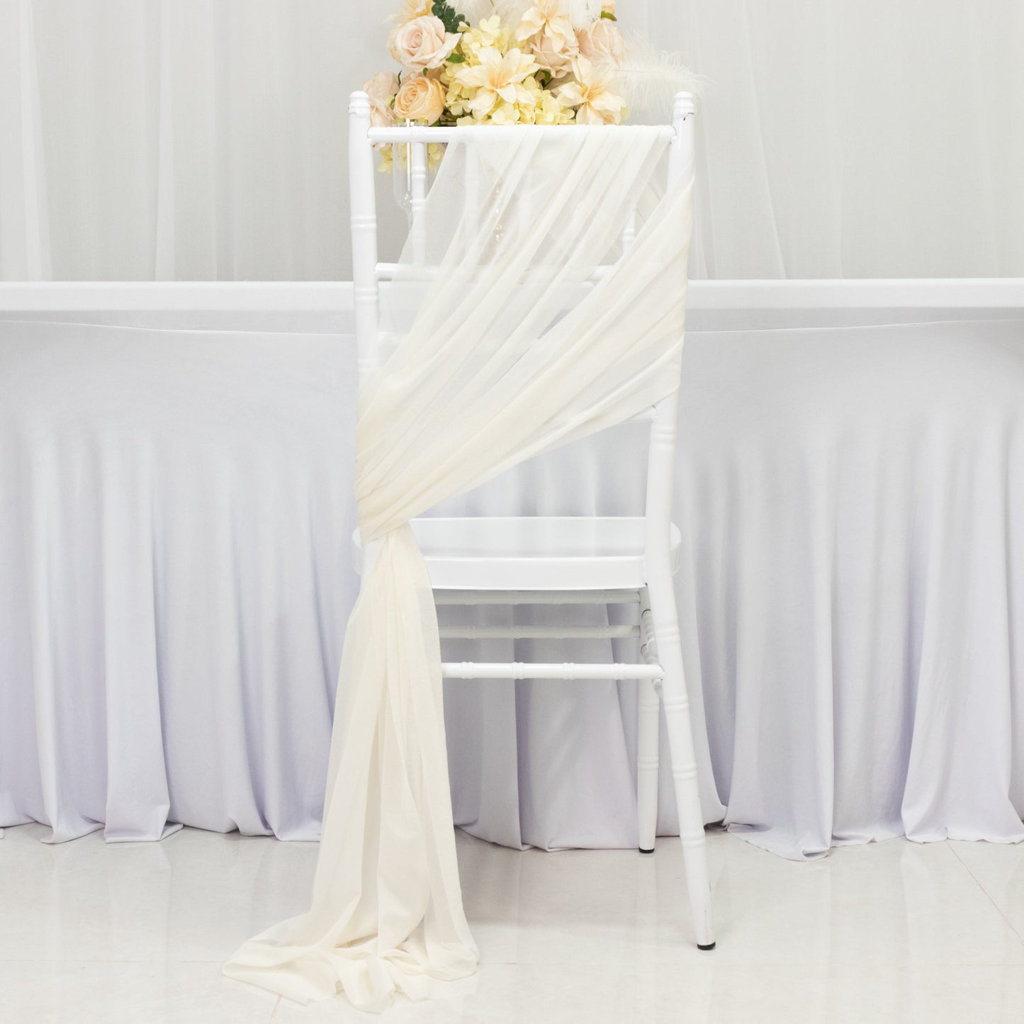 Ivory sheer chair drape with 9ft sash, wrinkle-free decor for events.