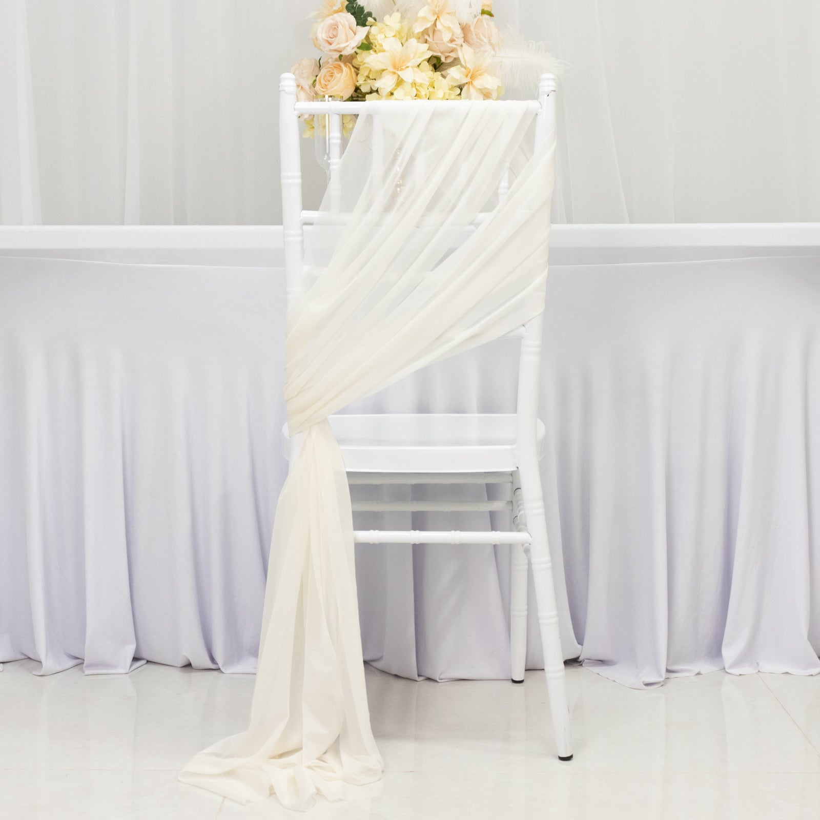 Ivory sheer chair drape with 9ft sash, wrinkle-free decor for events.