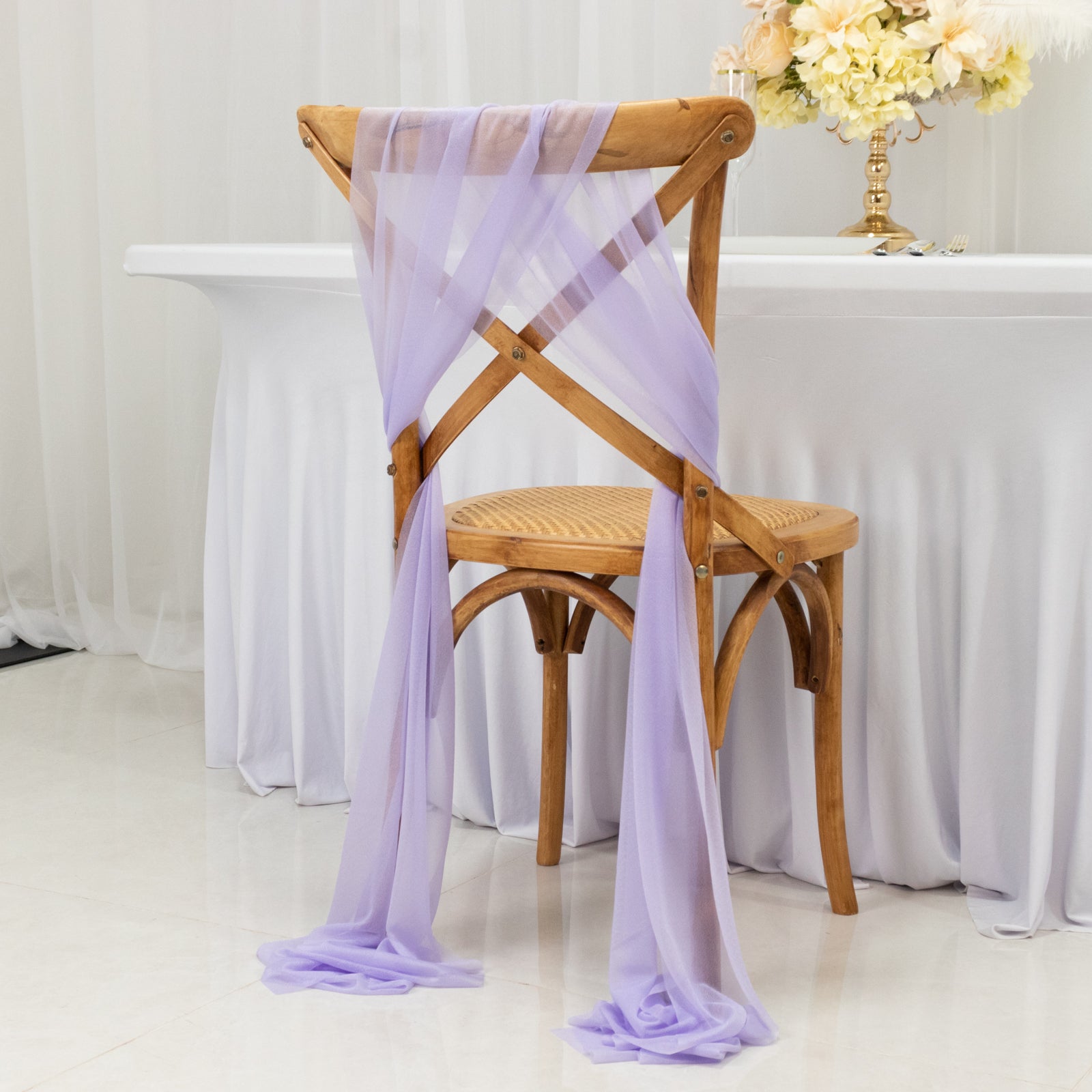 Lavender sheer chair drape decor on a wooden chair.
