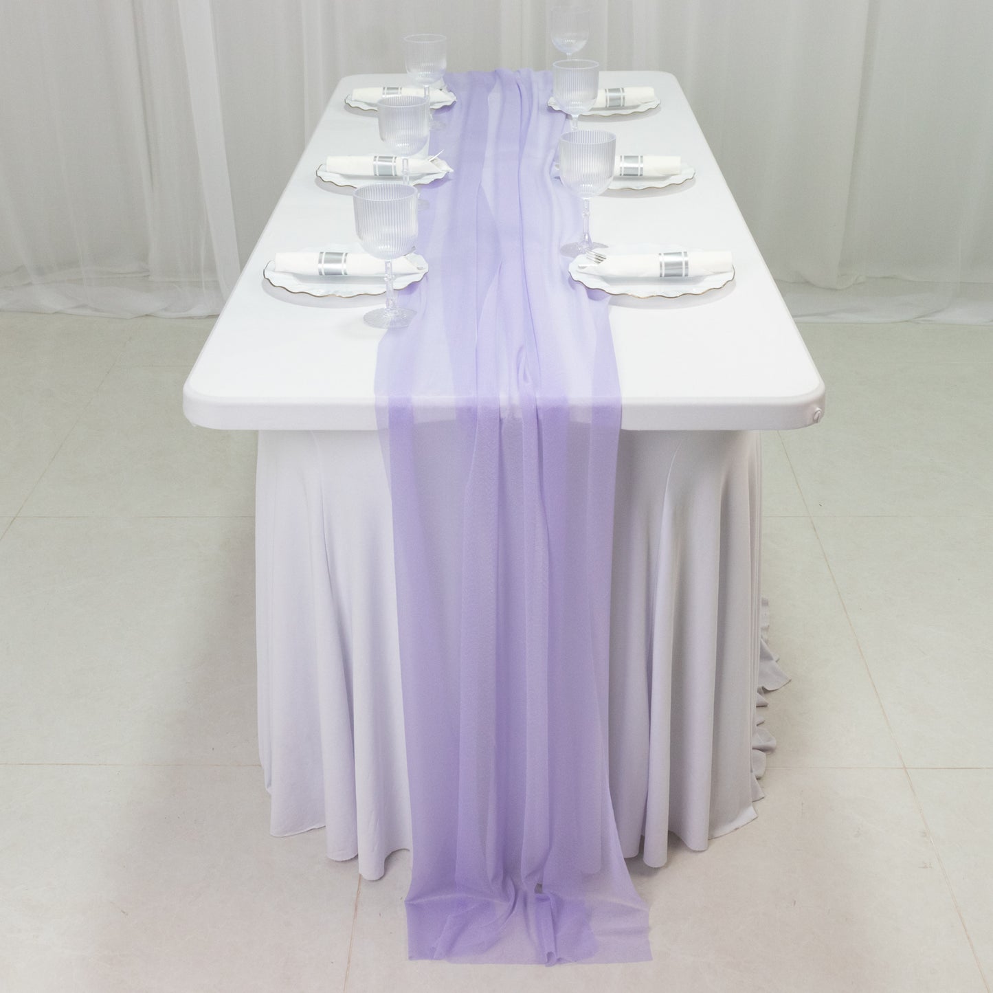 Lavender lilac sheer table runner draped on a white table.