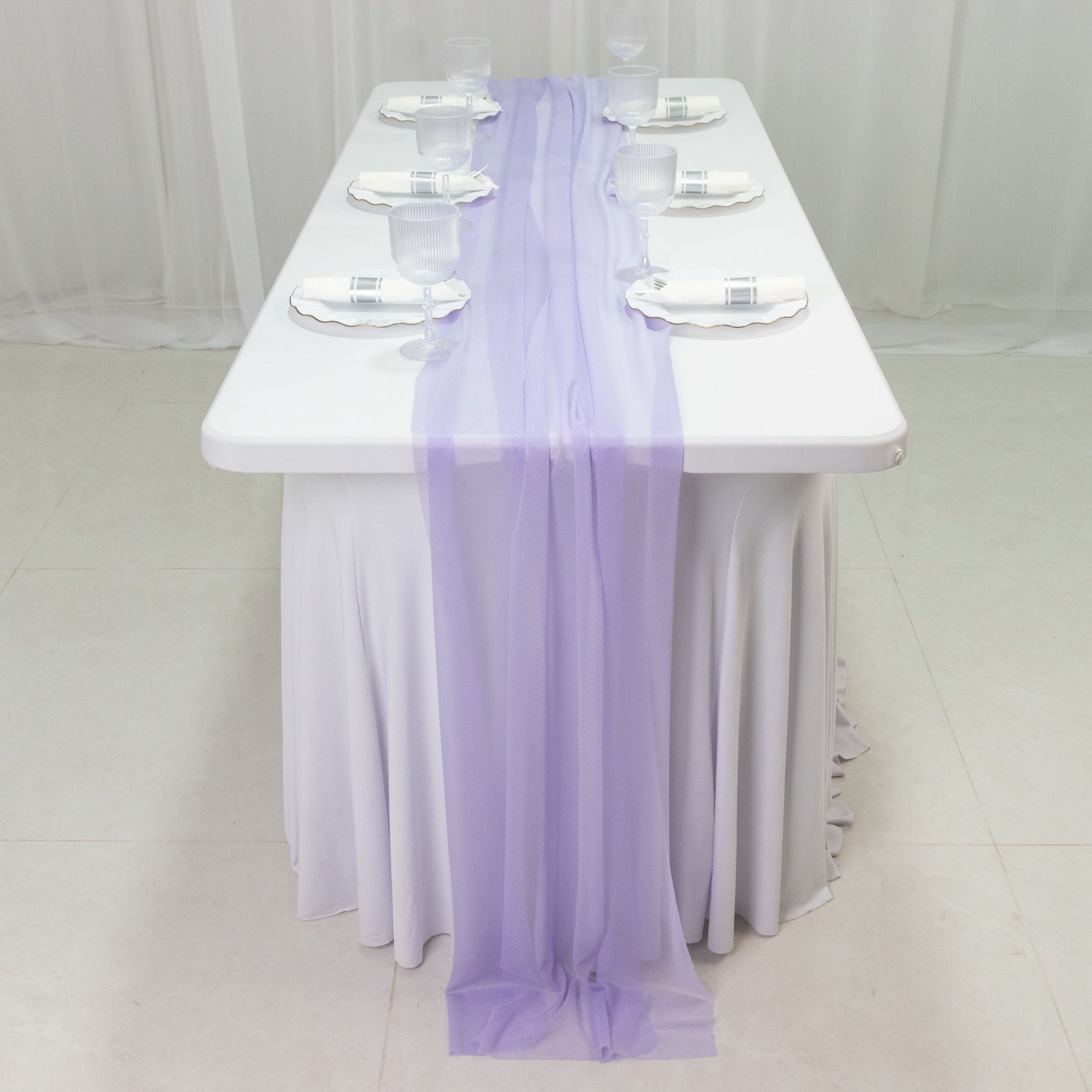 Lavender lilac sheer table runner draped on a white table.