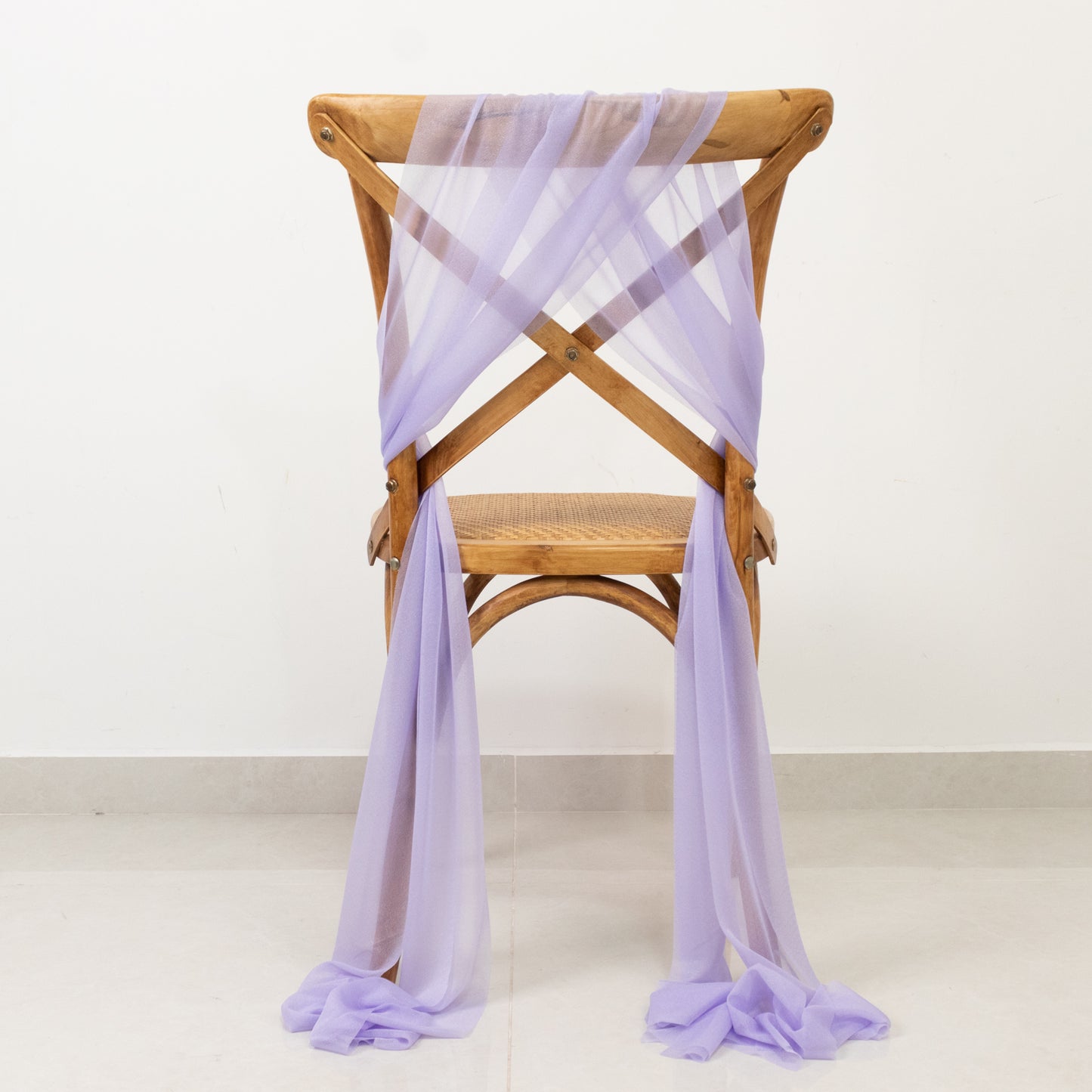 Lavender lilac sheer chair drape decor on wooden chair.