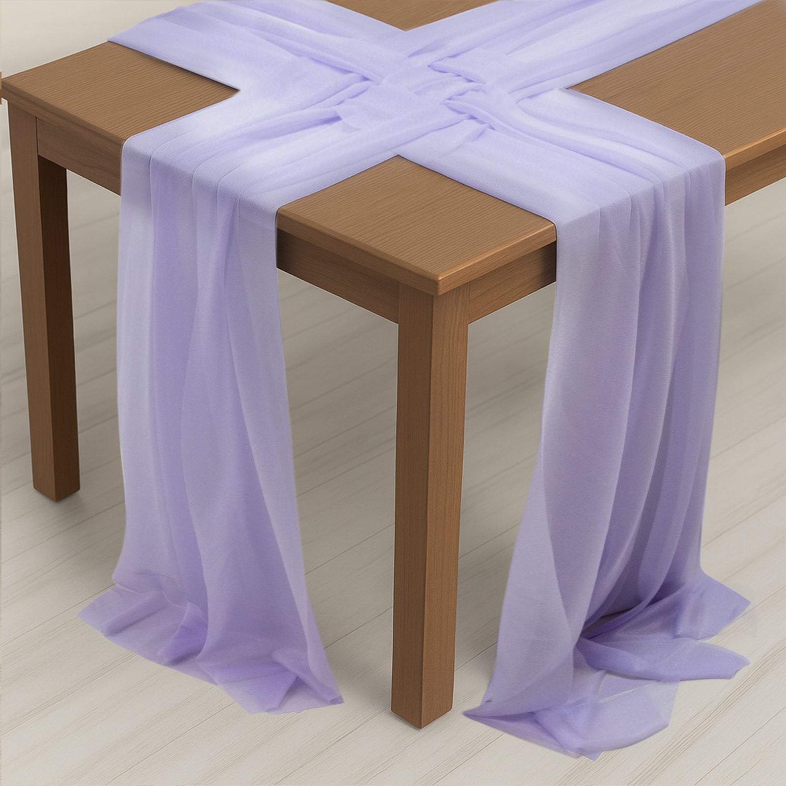 Lavender lilac shimmer sheer table runners draped over a wooden table.
