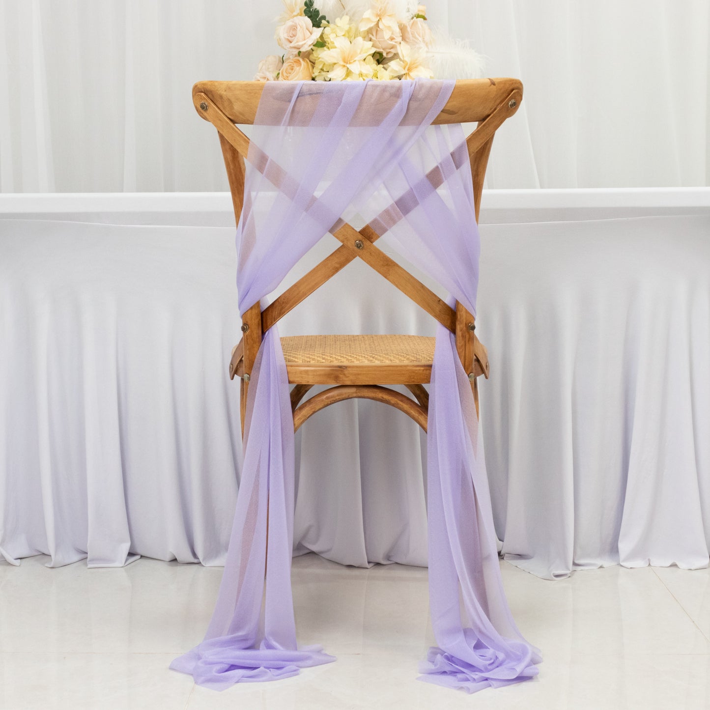 Lavender lilac sheer chair drape decor on a wooden chair.