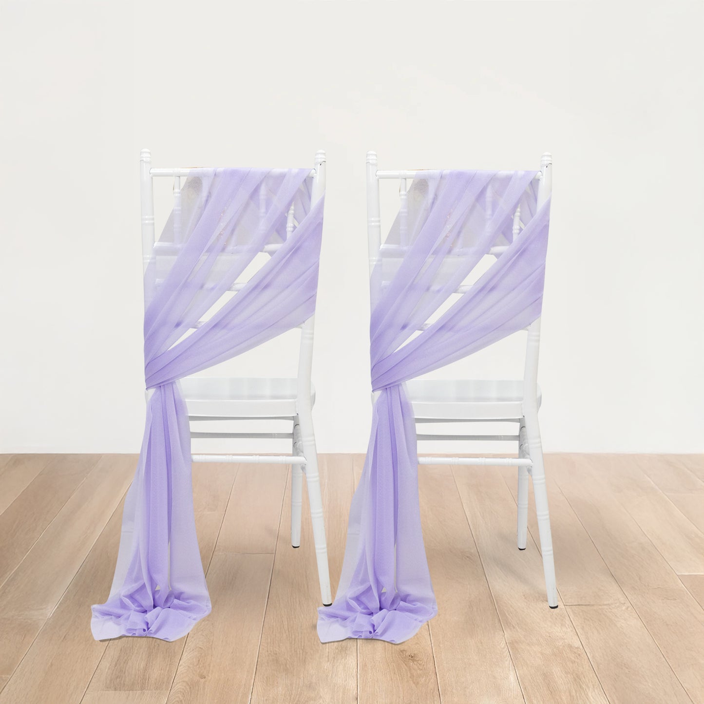 Lavender lilac sheer chair drape decor on white chairs.